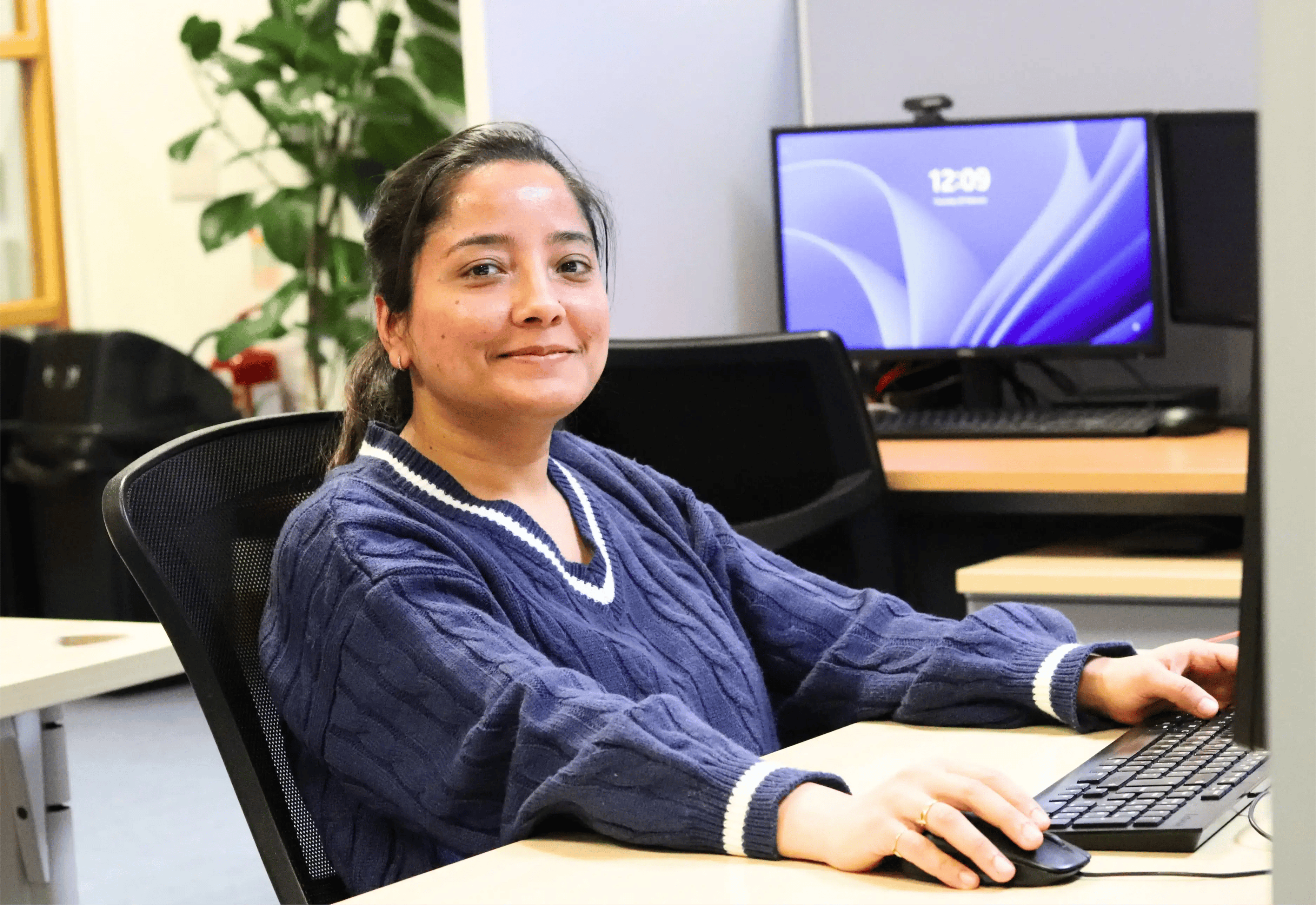 Taran working at her desk on LinkedIn 